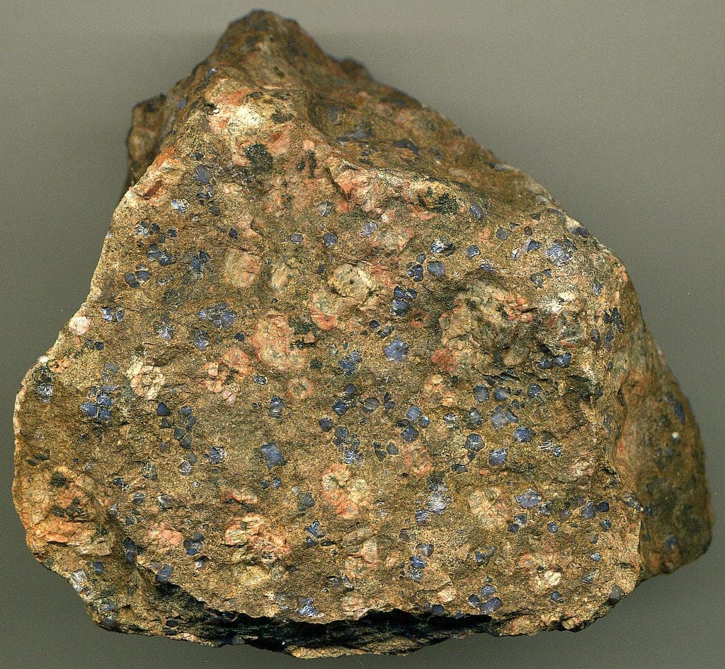 Llanite with phenocrysts of rare dark bluish quartz and orangish perthite - gem formation